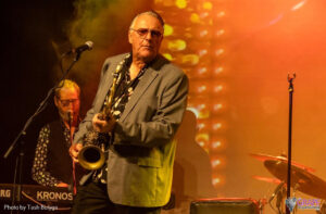 Wilbur Wilde looking at the camera while holding a saxophone.